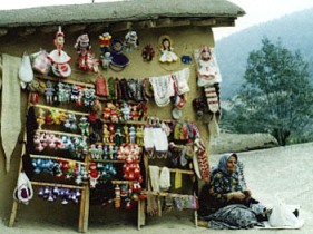 A woman offering her colorful trinkets