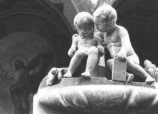 Cemetary statuary of a child comforting another
